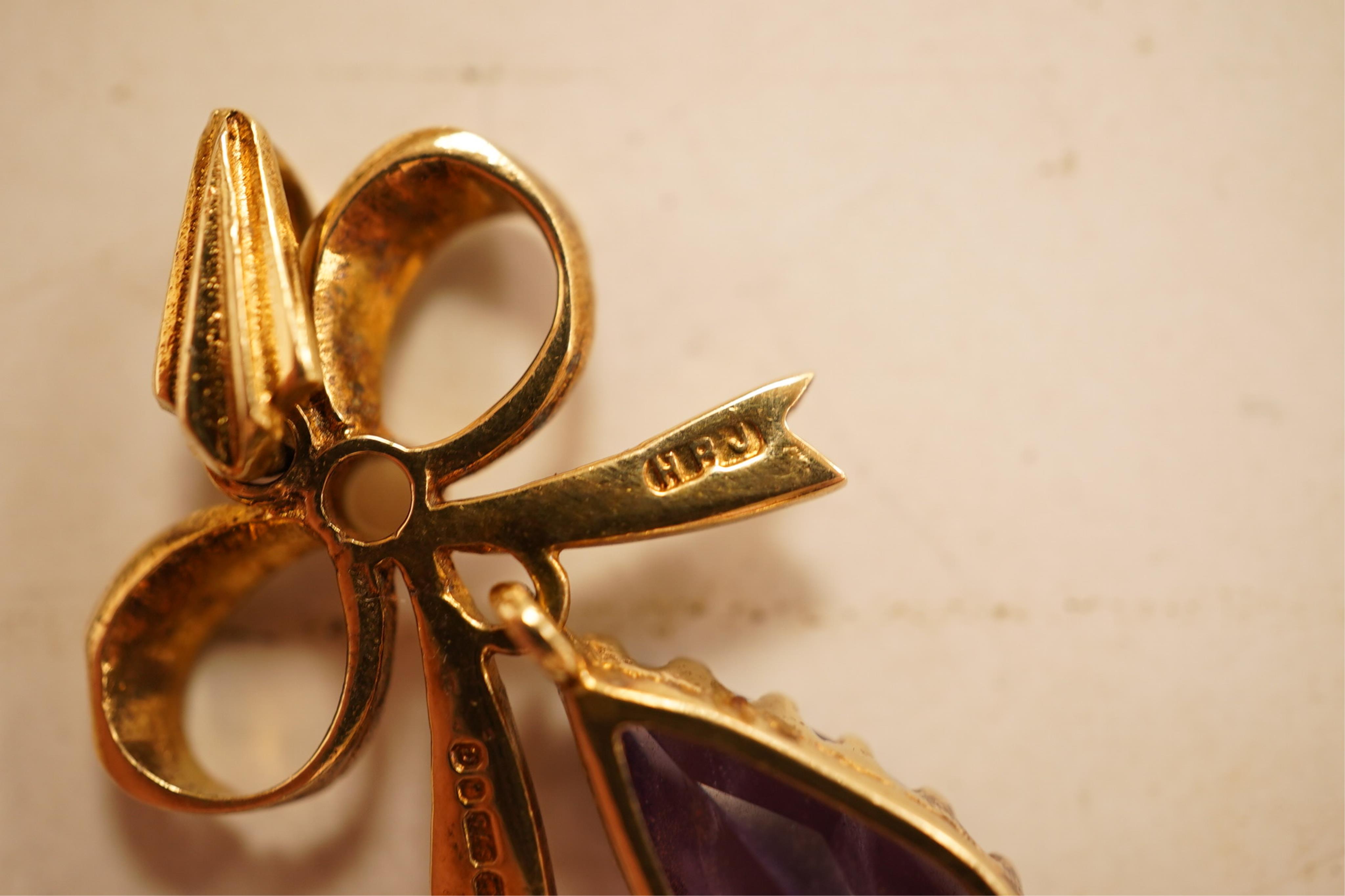 A 1970's 9ct gold, amethyst and seed pearl set drop pendant, 29mm, together with a yellow meta and amethyst set drop pendant.